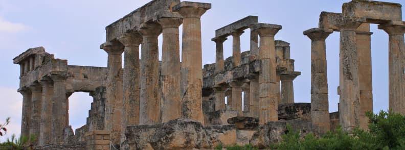 Temple of Aphaia on Aegina island Greece with ancient stone columns and hillside surroundings