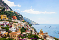Colorful cliffside buildings and Mediterranean coastline on the Amalfi Coast in Italy.