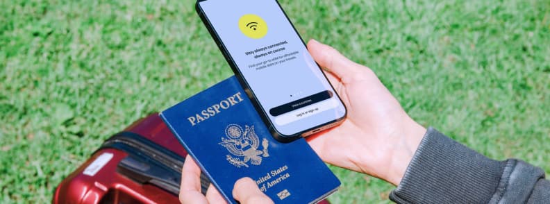 One eSIM for Multiple Mediterranean Countries Traveler holding a US passport and smartphone with an eSIM connection before a multi-country Mediterranean Europe trip.
