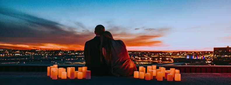Toronto Two Day Itinerary for Couples at Sunset Couple sitting beside candles overlooking city lights at sunset during a romantic two-day Toronto itinerary.
