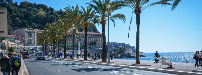 French Riviera in November Quiet Nice Coast in Autumn French Riviera in November along the Promenade des Anglais in Nice, with palm trees, pedestrians and bright Mediterranean sunshine.