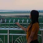 Jessica Harris Travel Writer Author Profile Travel writer Jessica Harris standing on a terrace overlooking a wide landscape during her travels.
