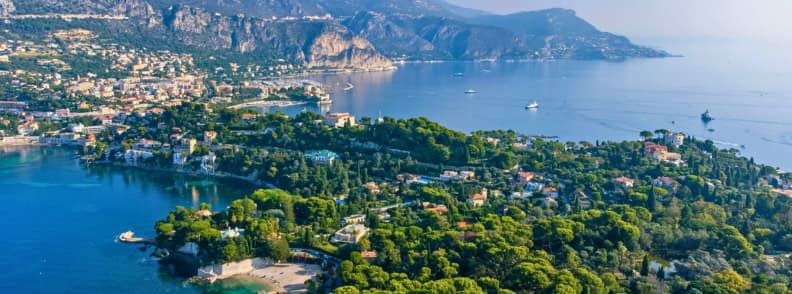 September on the French Riviera Warm Sea and Sailing September on the French Riviera, with Cap-Ferrat, Villefranche-sur-Mer and calm Mediterranean water dotted with sailboats.