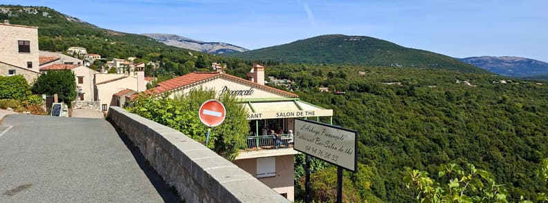 Auberge Provencale Mons Var Terrace View Auberge Provençale in Mons Var, with its panoramic terrace overlooking the green hills and mountain landscape below the village.