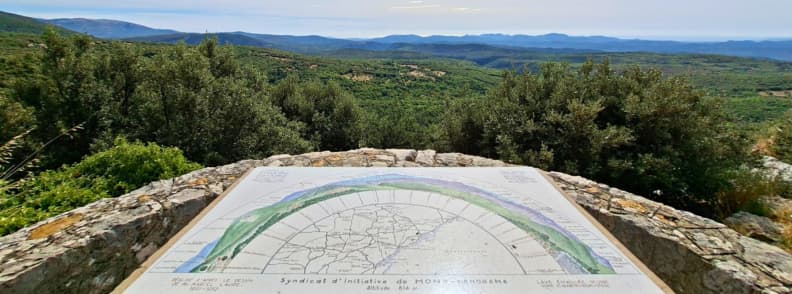 Place Saint Sebastien Panorama Mons Var Viewpoint Orientation table at Place Saint-Sébastien in Mons Var overlooking the wooded Pays de Fayence hills and distant Mediterranean landscape.