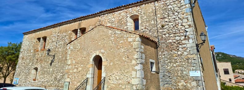 White Penitents Chapel Mons Var Heritage Site White Penitents Chapel in Mons Var, a historic stone chapel with a simple arched entrance in the old village center.